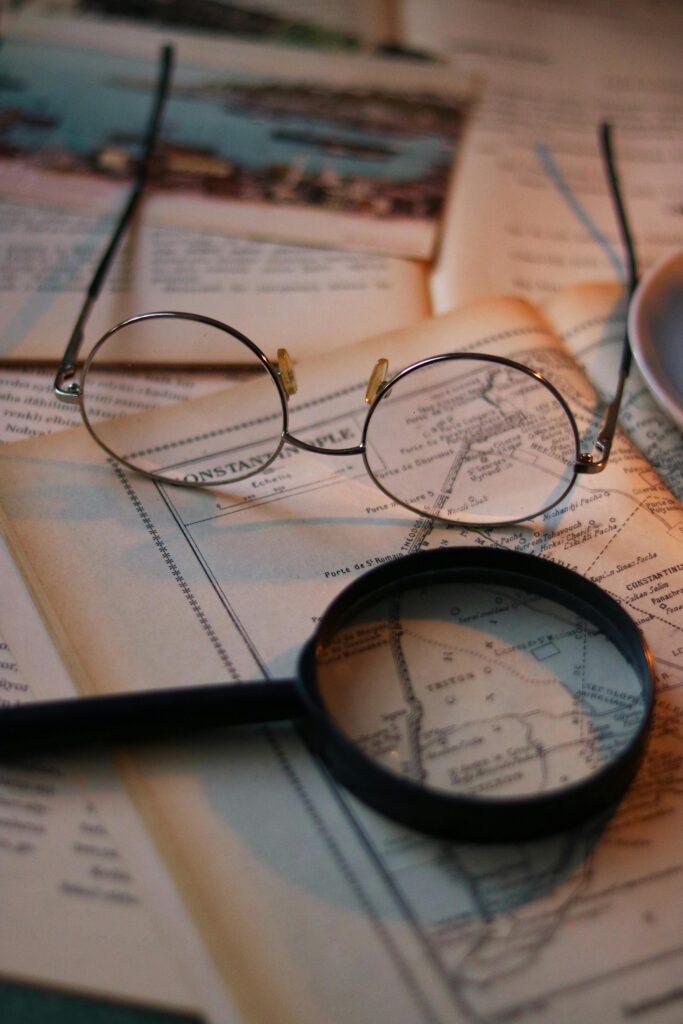 ancestry investigator, about ancestry investigator, genealogist services, discover family history, a magnifying glass and a magnifying glass on a map