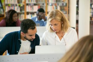 ancestry investigator, genealogy services, discover your family tree, a group of people looking at a laptop